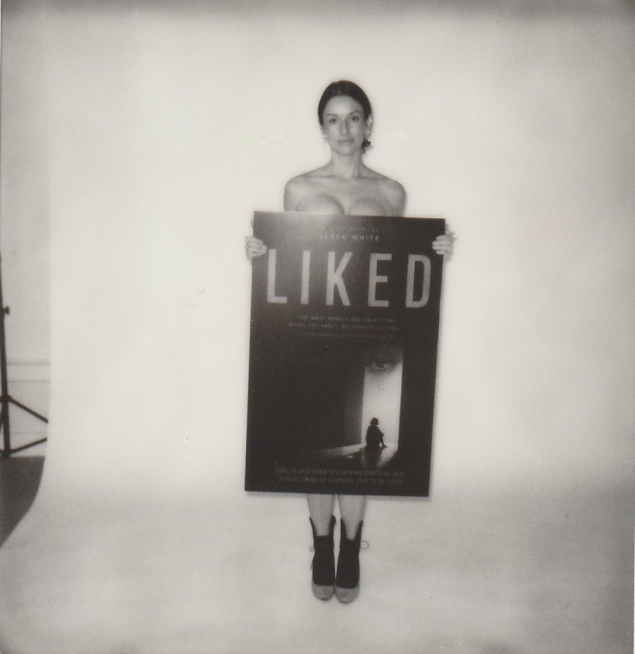 Jessa standing behind a Liked poster