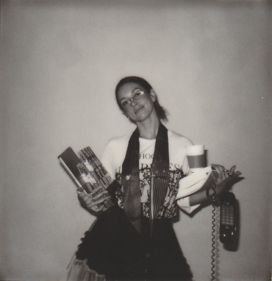 Jessa holding copies of Liked, a coffee and a phone